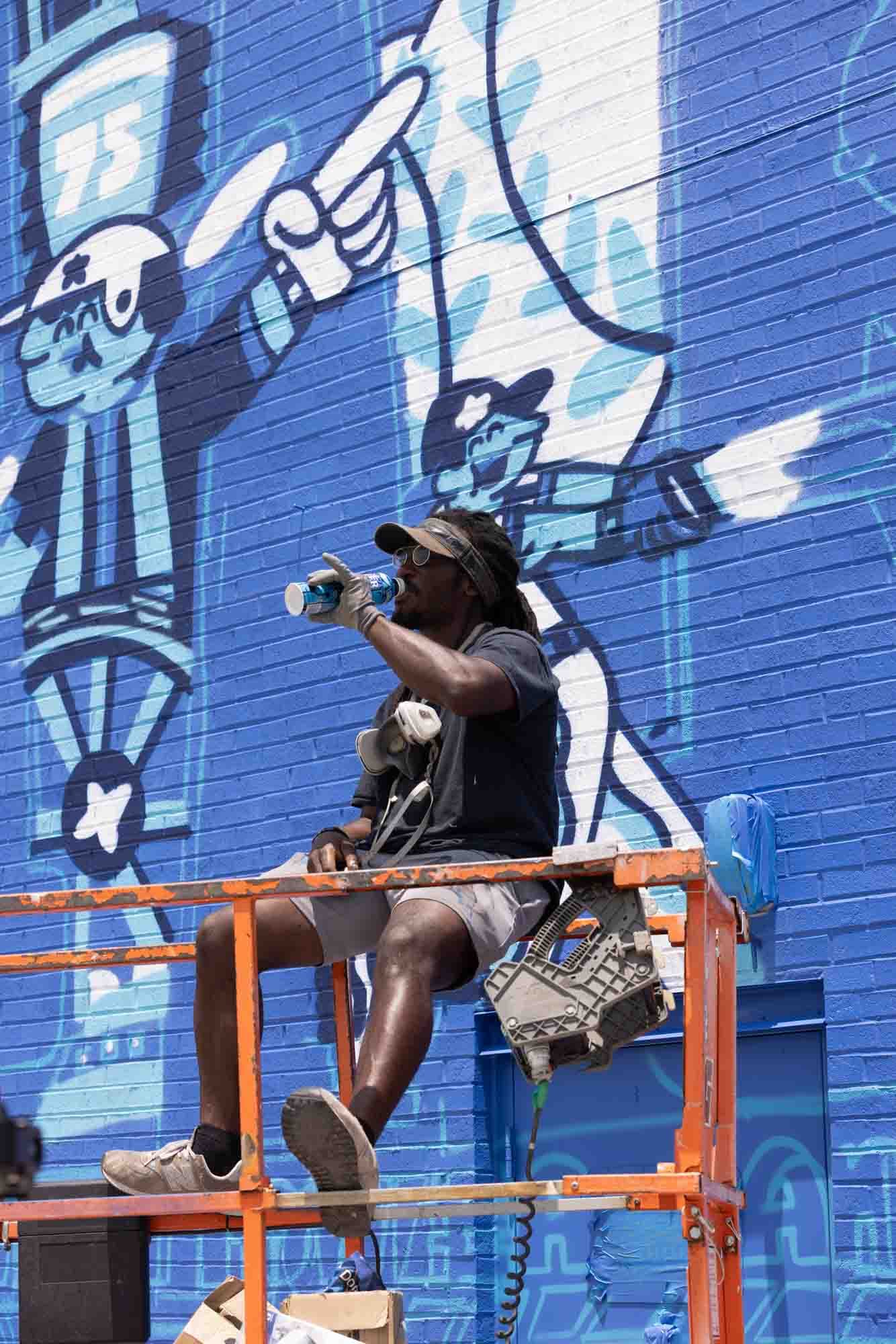 George F. Baker III painting the mural